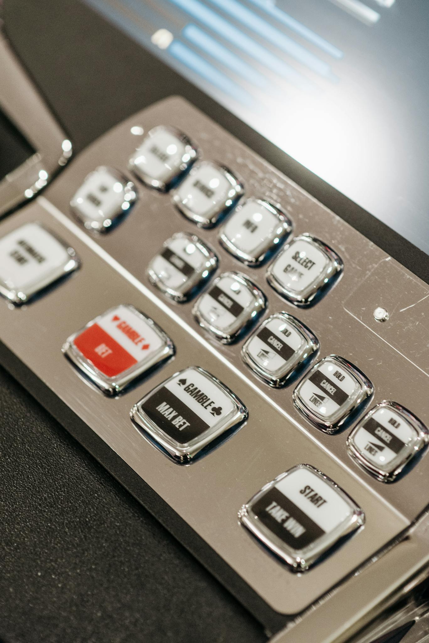 Detailed view of slot machine control panel buttons in a casino setting.